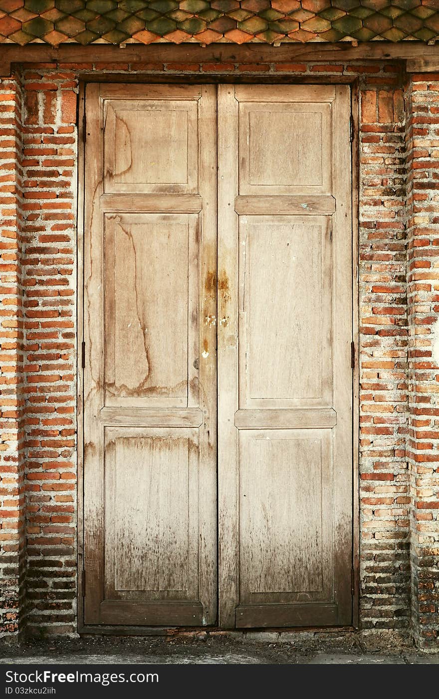 Old wooden doors and old brick wall