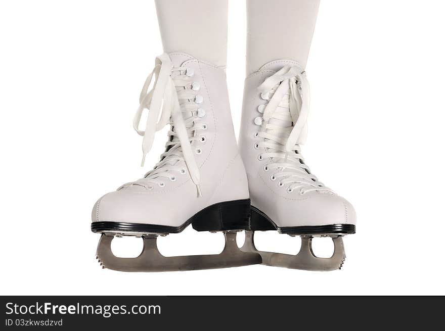 A girl's legs wearing ice skates against a white background. A girl's legs wearing ice skates against a white background