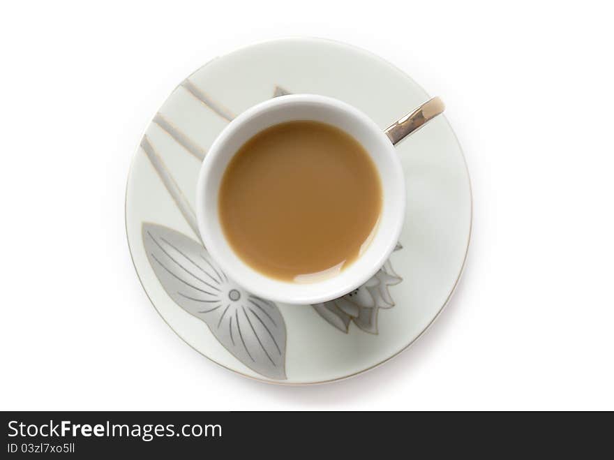 Cup of coffee with milk or cream and saucer