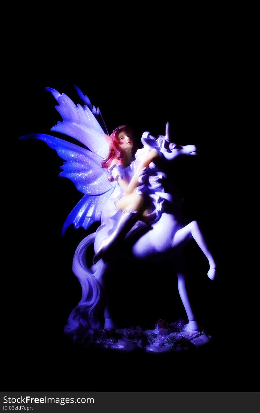 Magic fairy figure riding unicorn