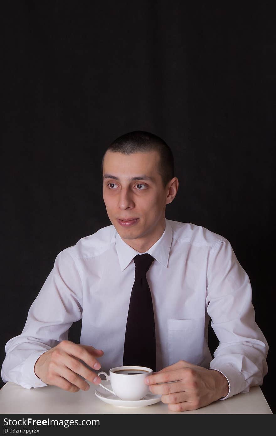 Portrait of businessman drinking coffee on black. Portrait of businessman drinking coffee on black