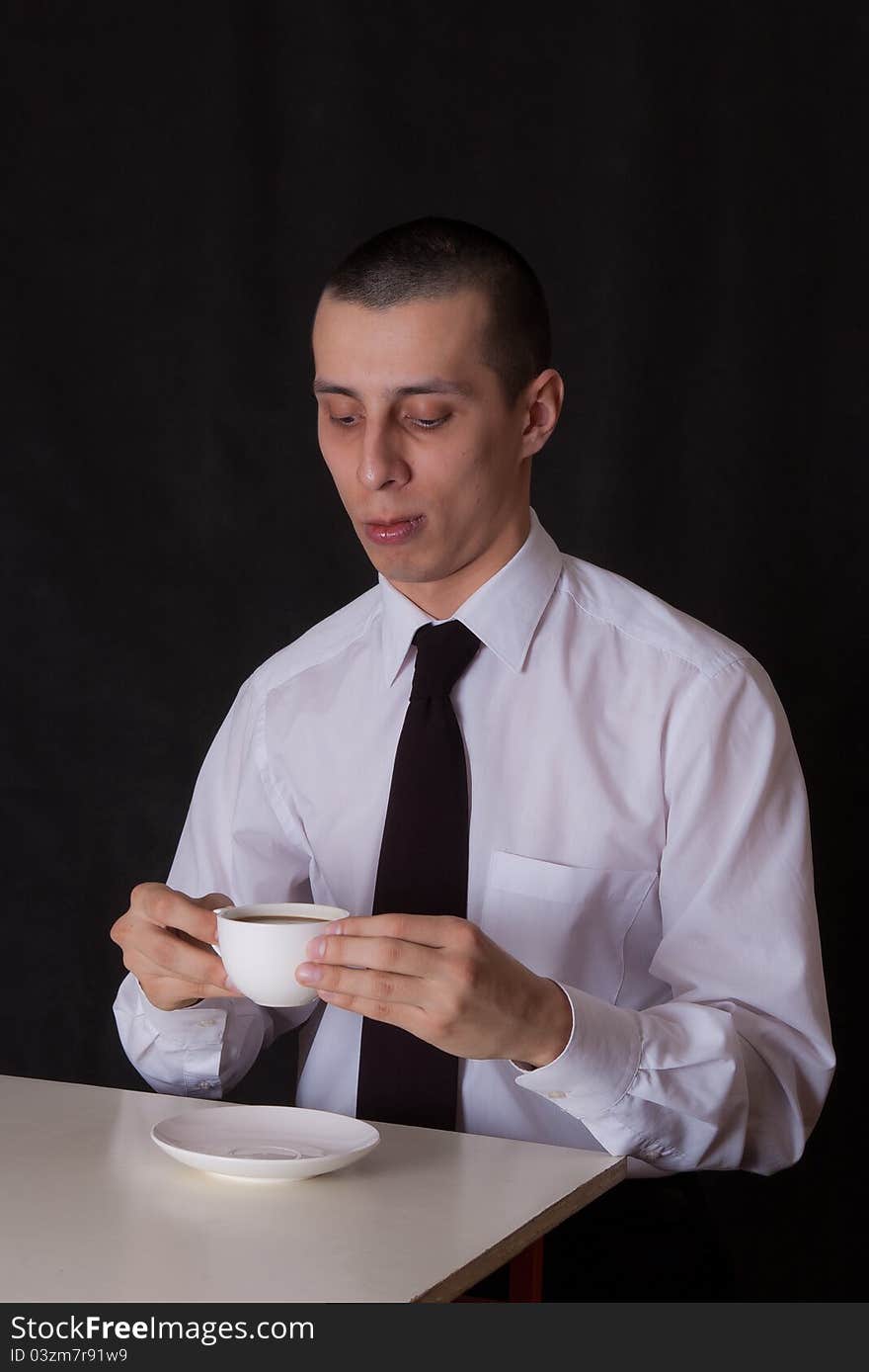 Thoughtful businessman drinking coffee