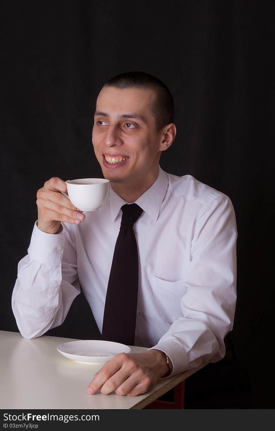 Portrait of businessman drinking coffee on black. Portrait of businessman drinking coffee on black