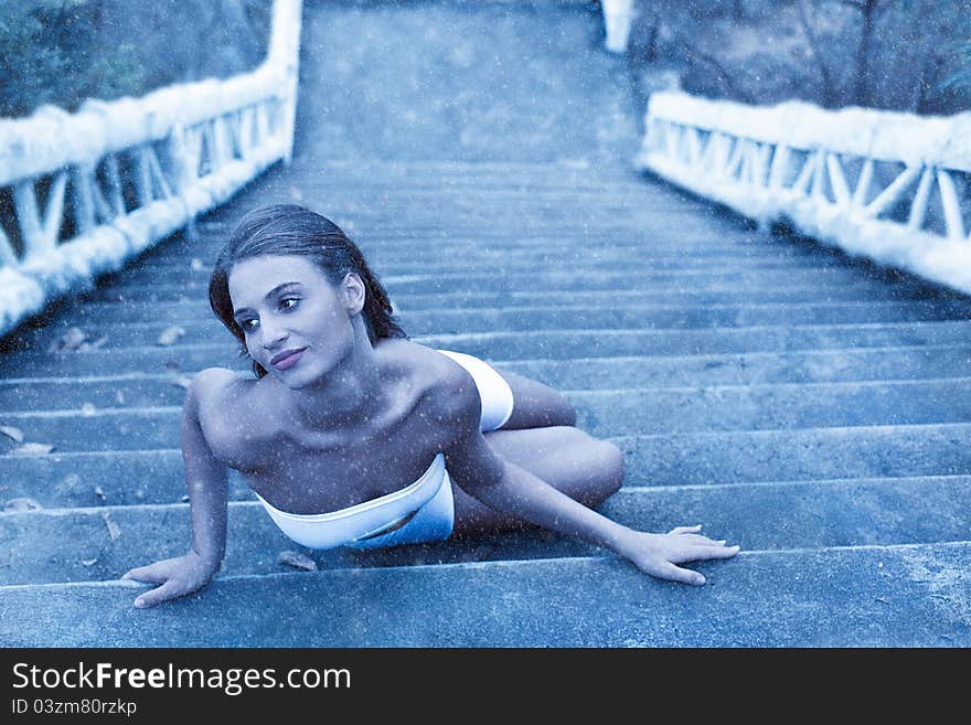 Fabulous woman lying on icy stairs