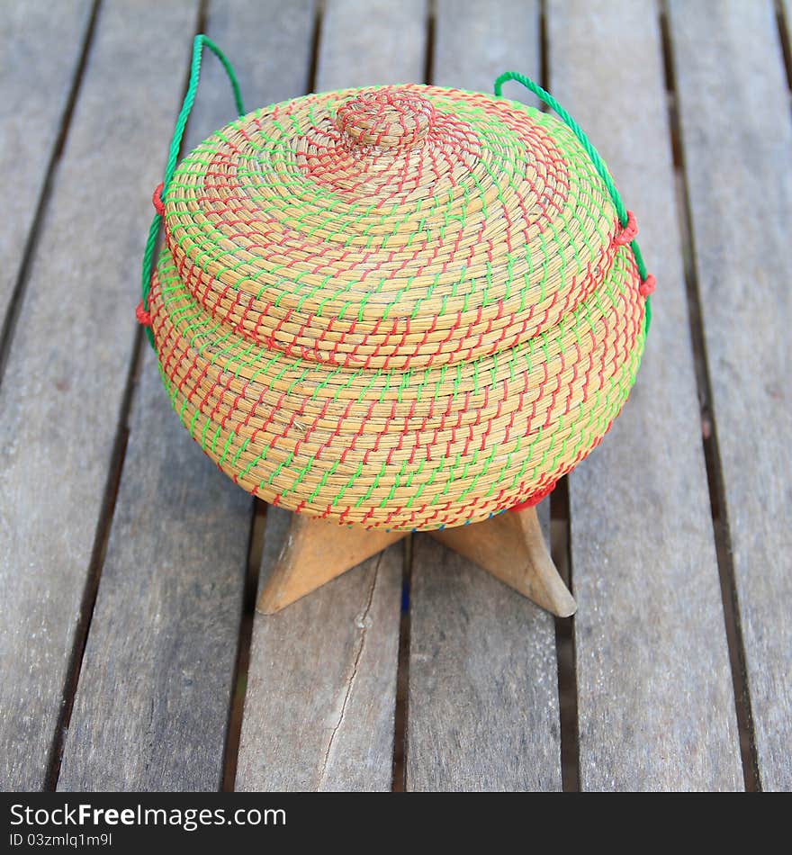 Rice Box Made From Bamboo And Nylon On Old Wooden.