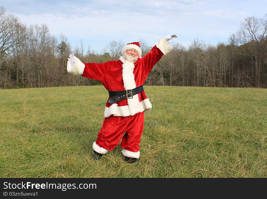 Happy Santa Claus dancing in an open field. Happy Santa Claus dancing in an open field.