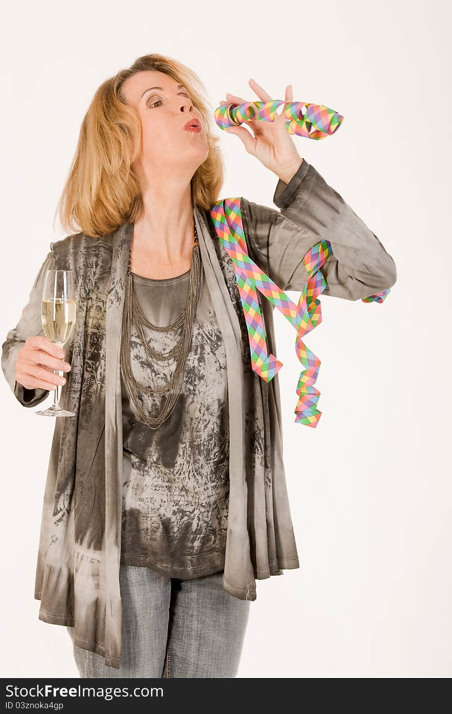 Elderly lady celebrates with champagne and streamers. Elderly lady celebrates with champagne and streamers