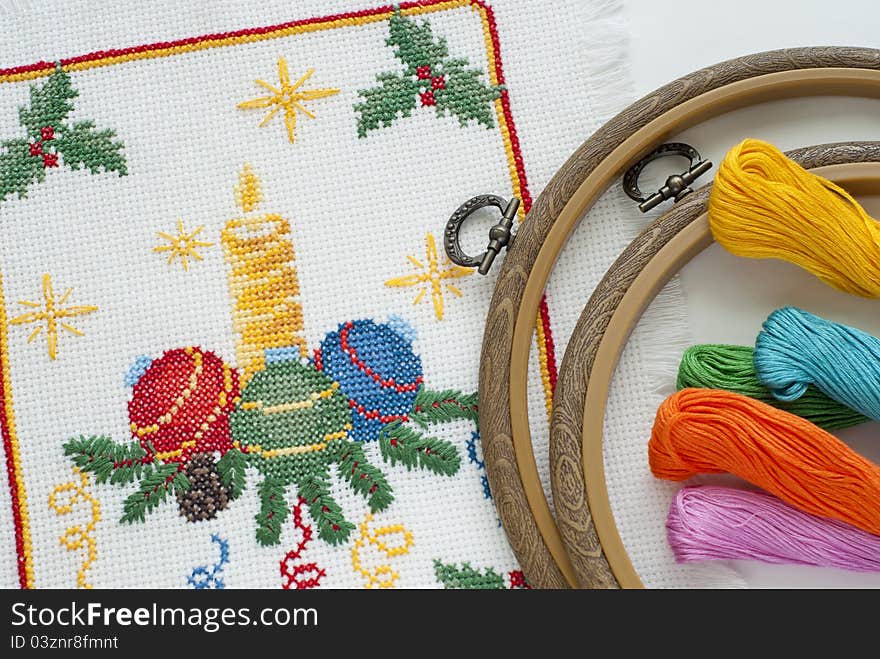 Christmas embroidery a cross on a white canvas. Christmas embroidery a cross on a white canvas