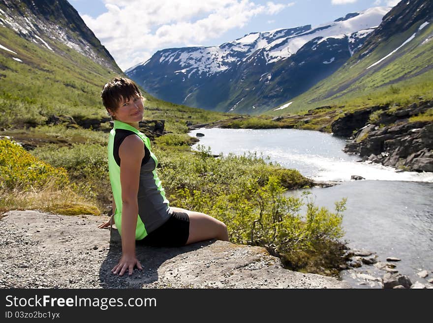 The sport girl near the mountain river