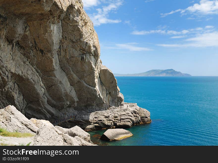 Grotto at the foot of the mountain in the sea.