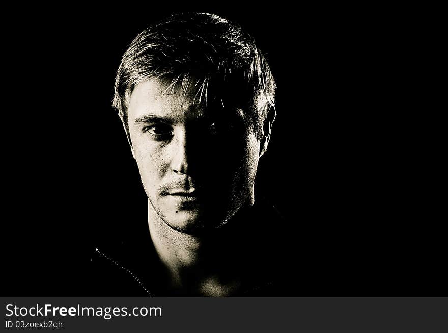 Black and white portrait of man on black background. Black and white portrait of man on black background