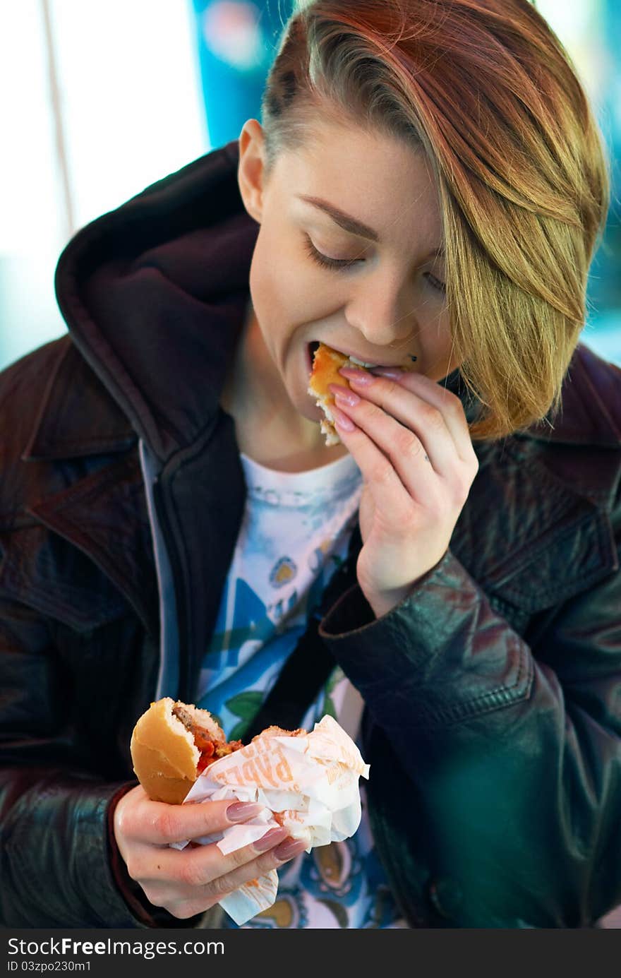 Portrait Of Girl With Eats Burger On The Terrace