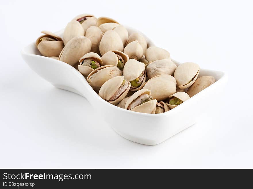 Pistachios on the white plate