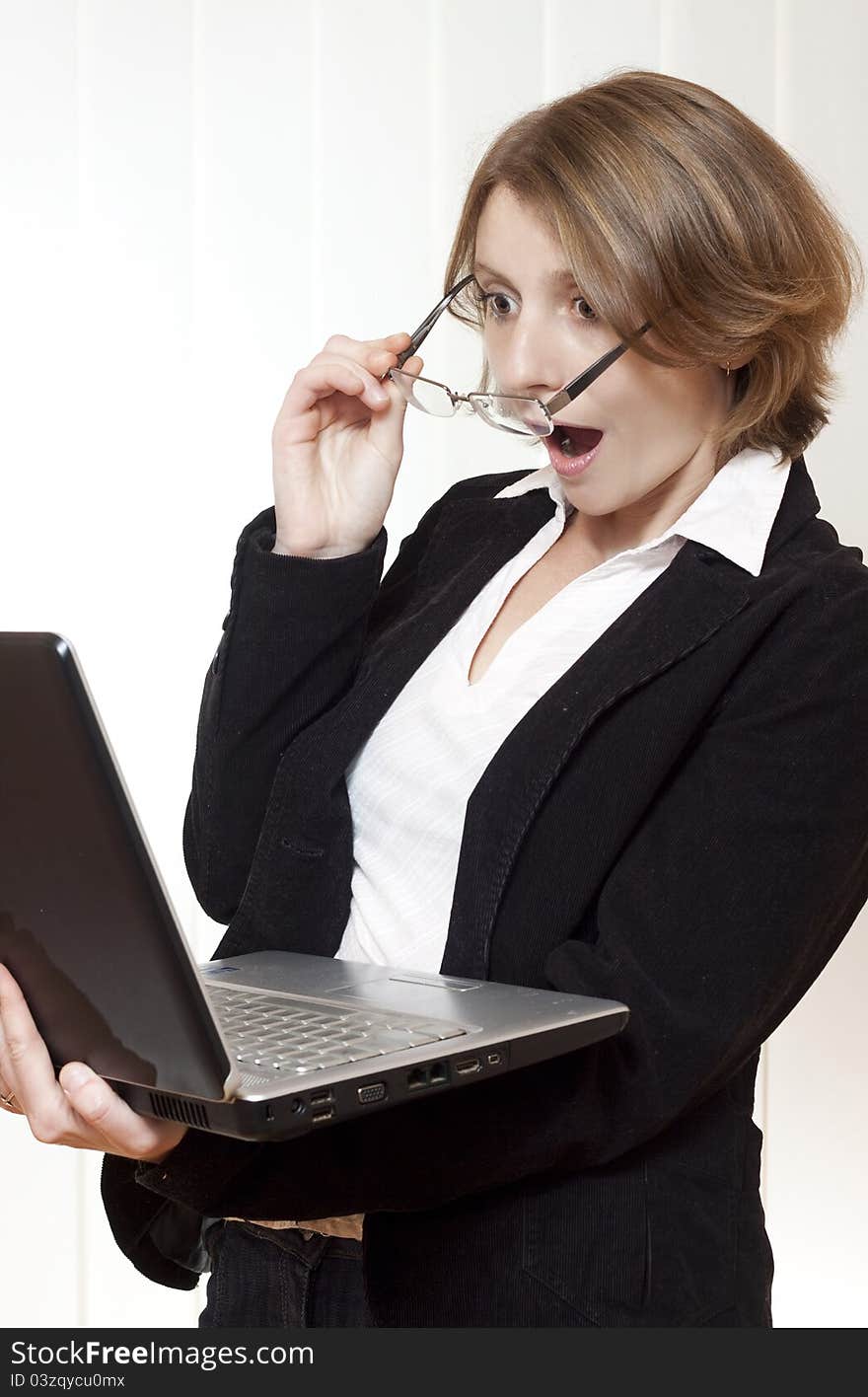 Surprised businesswoman looking at laptop