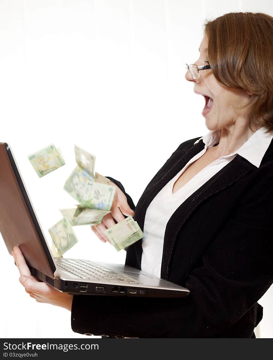 Businesswoman excited of money flying out of computer