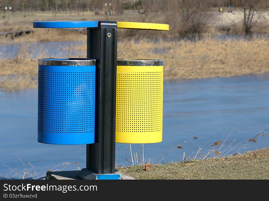 A colorized wastebin in river park