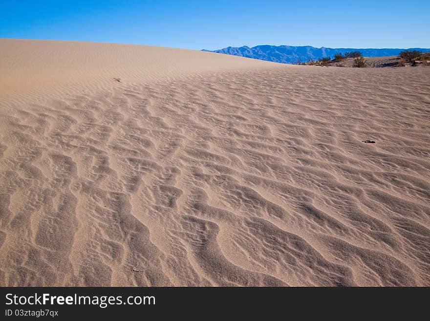 This image captures the intricate patterns of the Mesquite sand dunes in Death Valley National Park. This image captures the intricate patterns of the Mesquite sand dunes in Death Valley National Park.