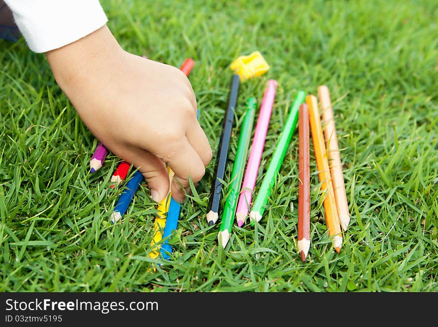 Children's hand picks colored pencil. Children's hand picks colored pencil