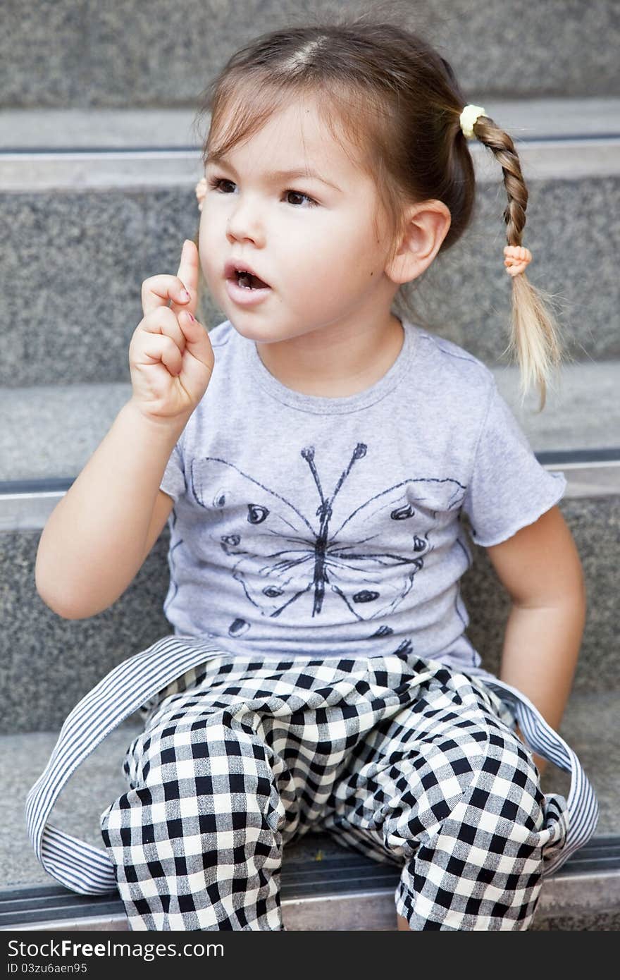 Cute little girl sitting on stairs, metizo. Cute little girl sitting on stairs, metizo