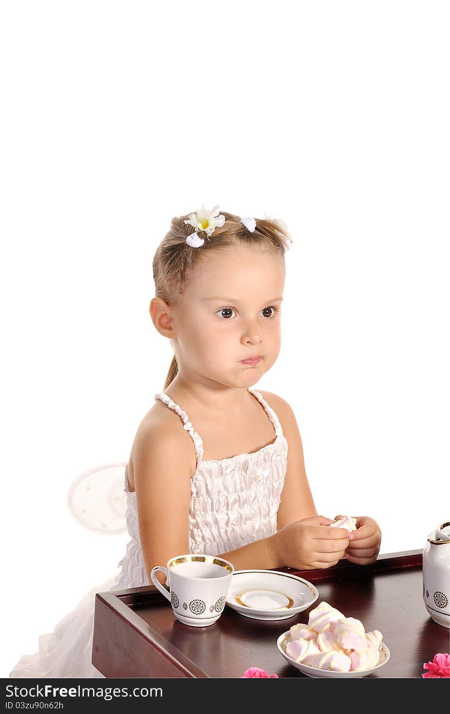 Nice little princess in beautiful white dress having tea with zephyr on white background. Nice little princess in beautiful white dress having tea with zephyr on white background