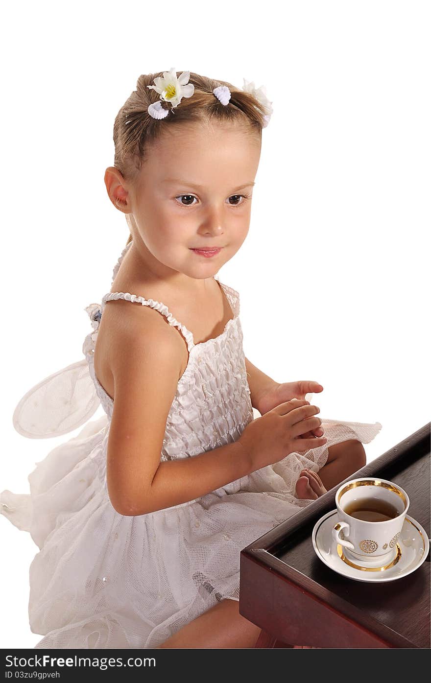 Nice little princess in beautiful white dress ans hazel eyes  having tea with zephyr  isolated on white background. Nice little princess in beautiful white dress ans hazel eyes  having tea with zephyr  isolated on white background