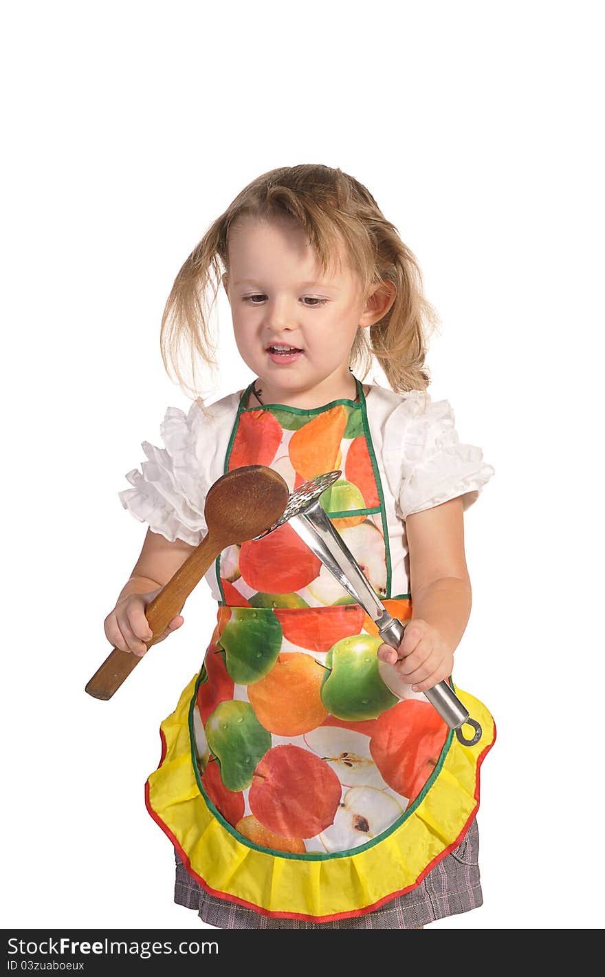 Little housewife in colourful apron isolated