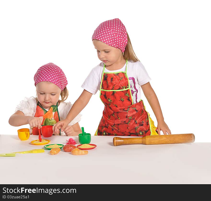 Two little housewifes in colourful aprons