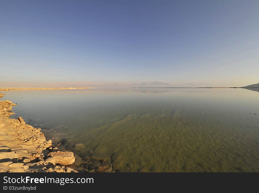 Calm surface of Dead Sea in winter and Jordan coast in the distance. Calm surface of Dead Sea in winter and Jordan coast in the distance.