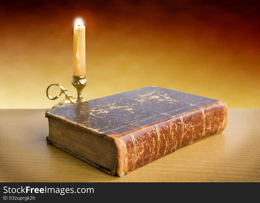 Candlestick and old book