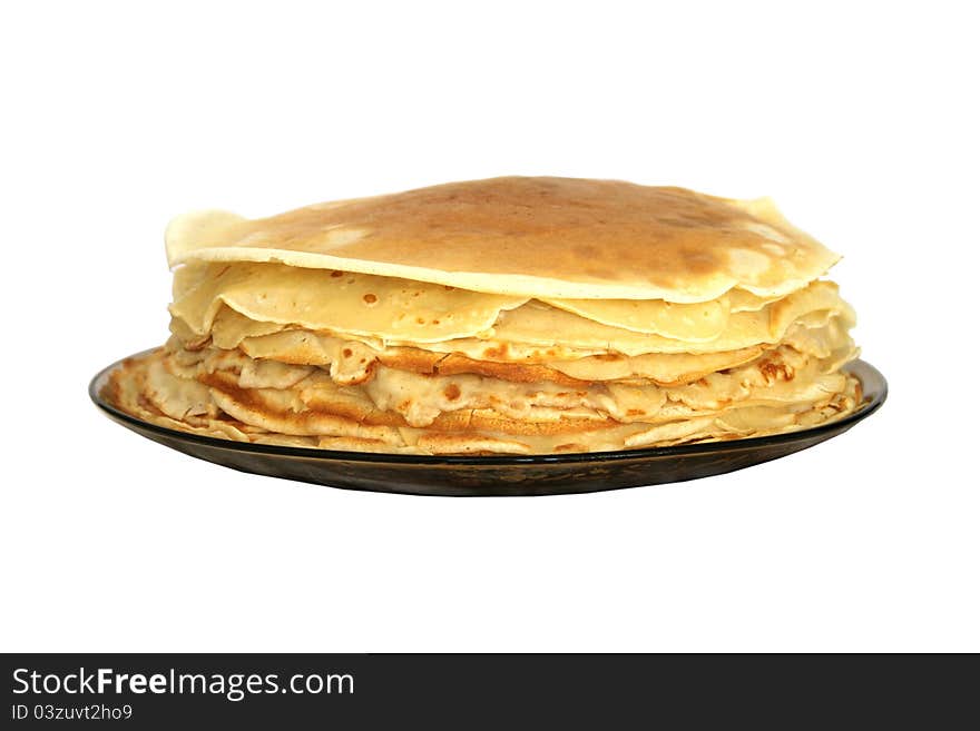 A stack of Russian thin pancakes on a dark plate isolated on white. A stack of Russian thin pancakes on a dark plate isolated on white