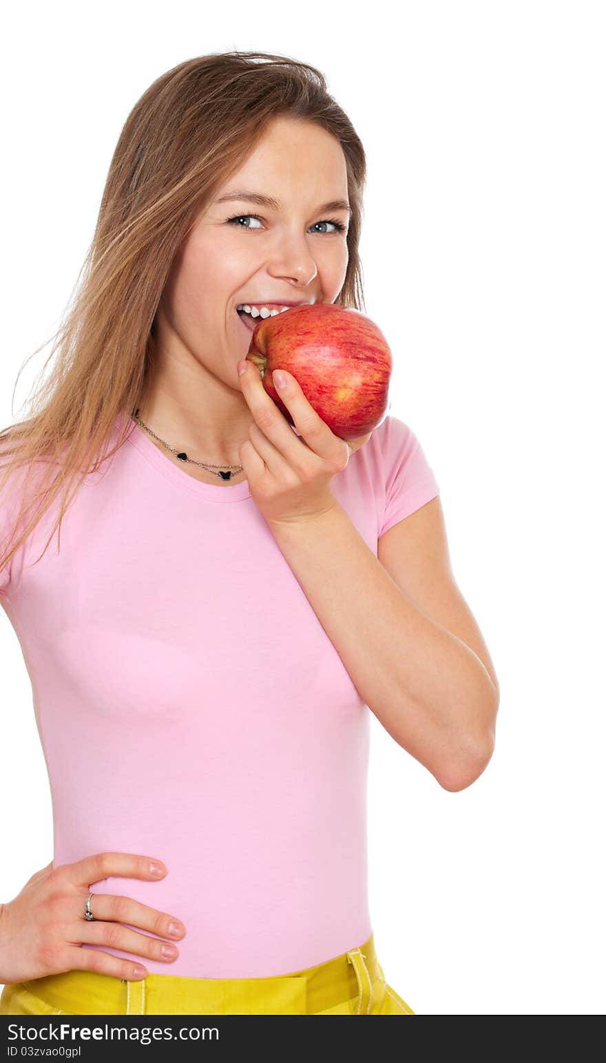 Young happy woman biitng apple