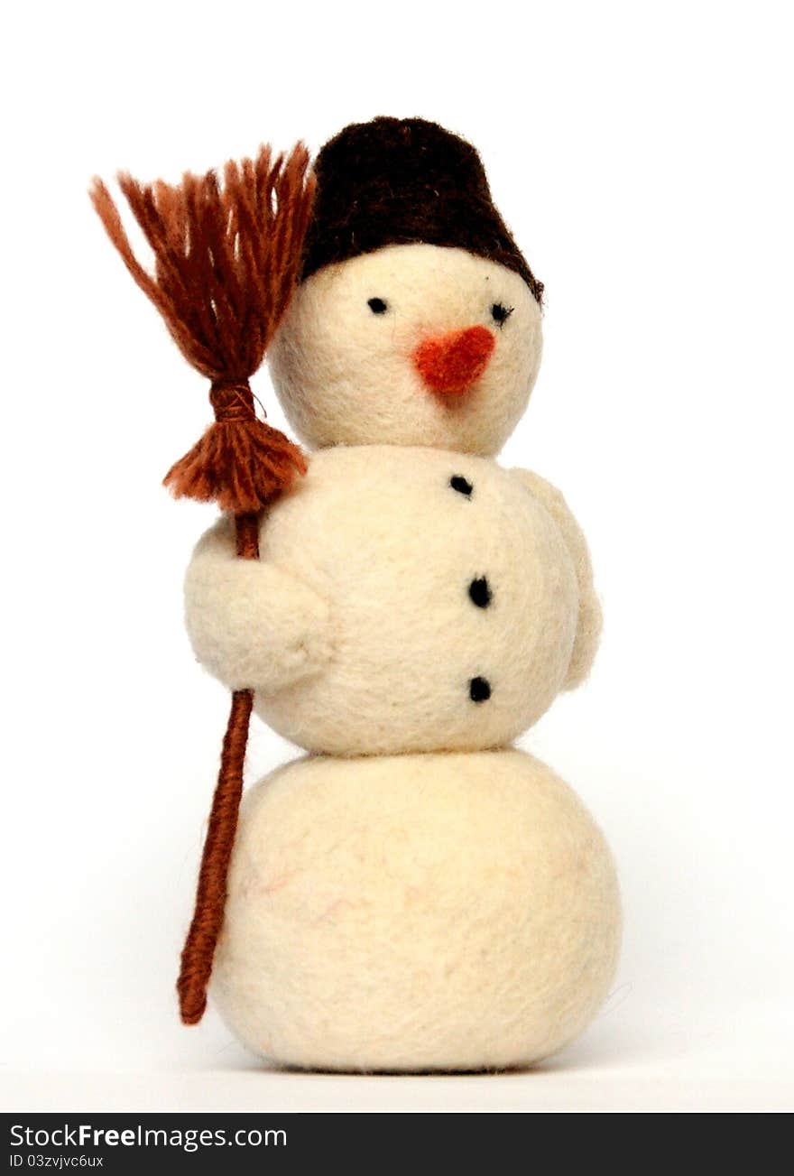 Toy - a cheerful snowman with broom on white background, close-up. Toy - a cheerful snowman with broom on white background, close-up