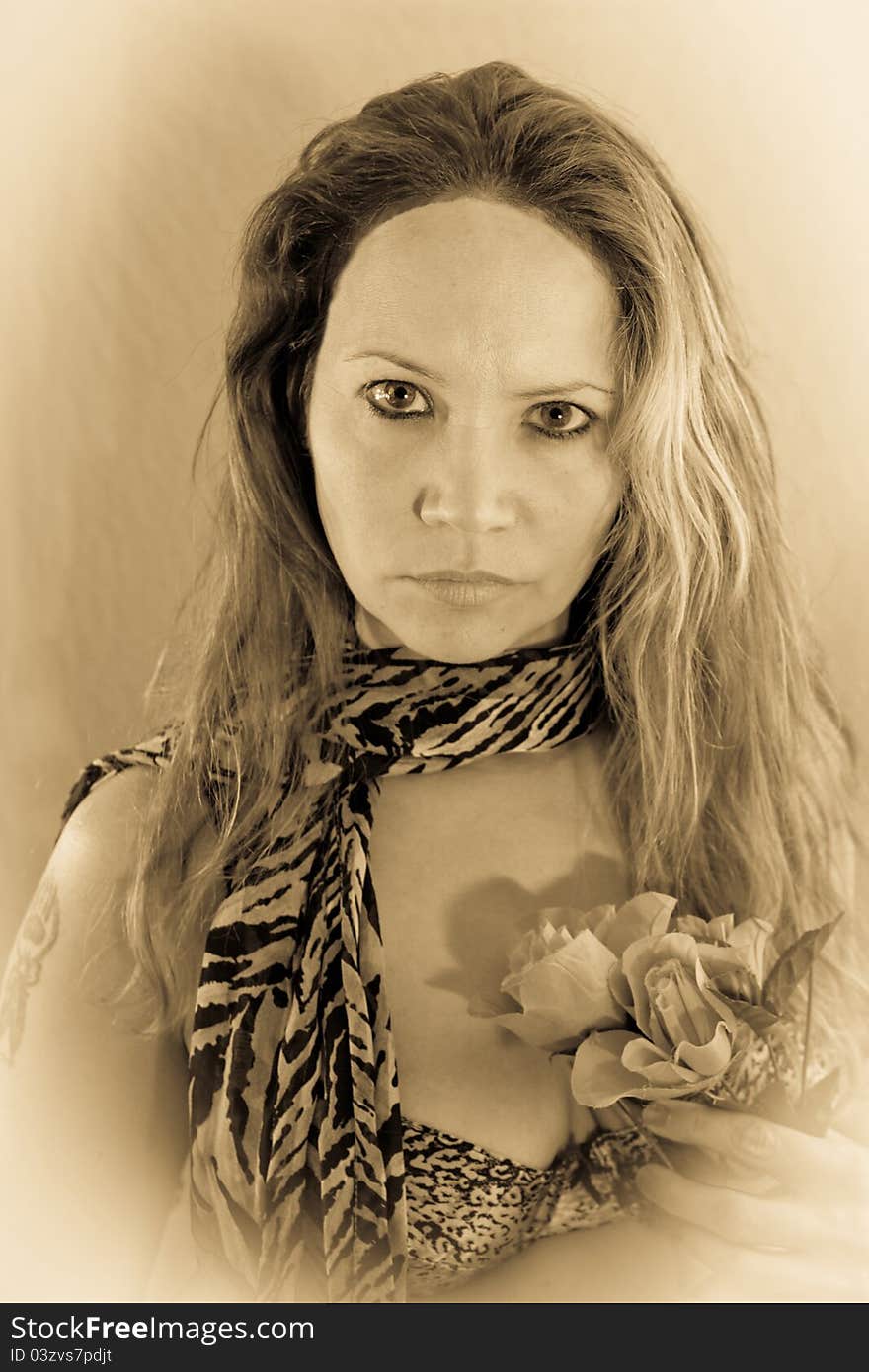 Faded female posing with a leopard scarf and flowers. Faded female posing with a leopard scarf and flowers