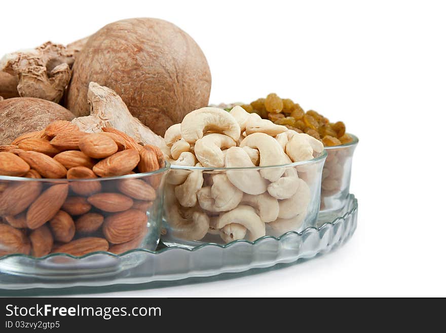 Mix collection of dry fruits in glass bowl isolated over white. Mix collection of dry fruits in glass bowl isolated over white