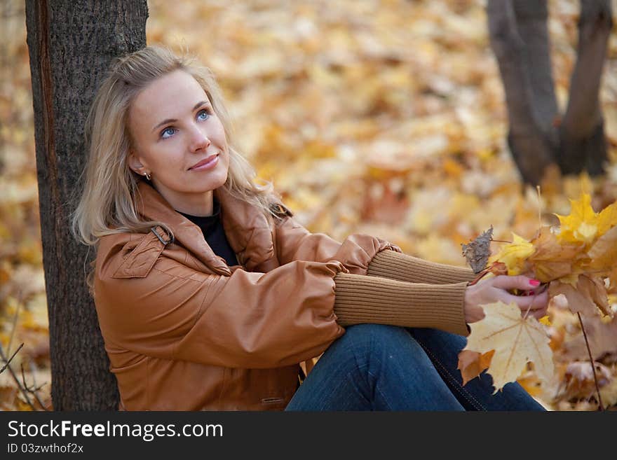 The girl on a walk in the autumn park