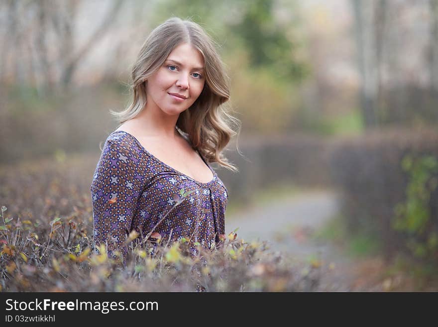 The girl on a walk in the autumn park