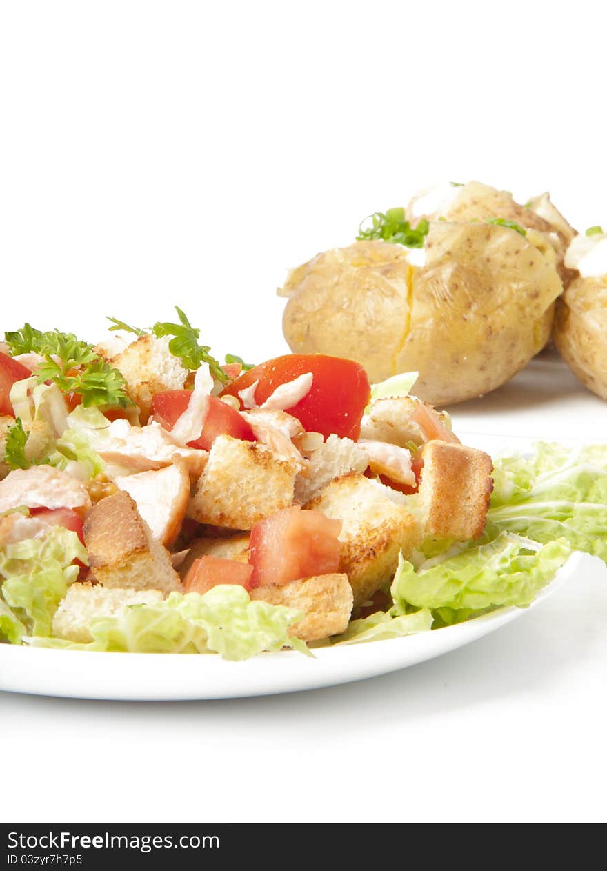 Delicious salad and baked potatoes on a white background