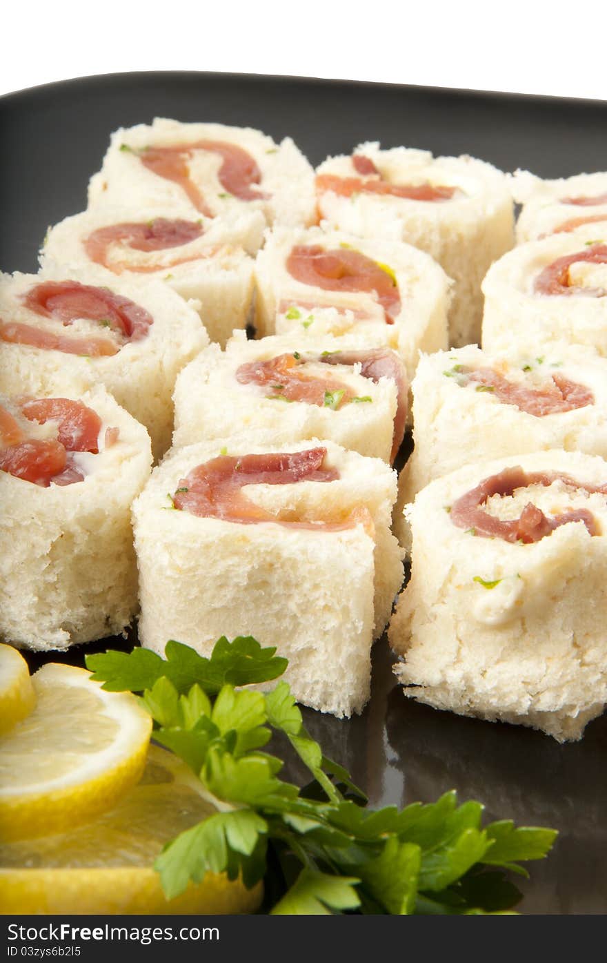 Smoked salmon rolls on white background