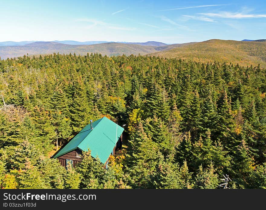 A view of a cabin from the Balsam Lake Mountain fire tower in early autumn in the Catskills Mountains of New York. A view of a cabin from the Balsam Lake Mountain fire tower in early autumn in the Catskills Mountains of New York