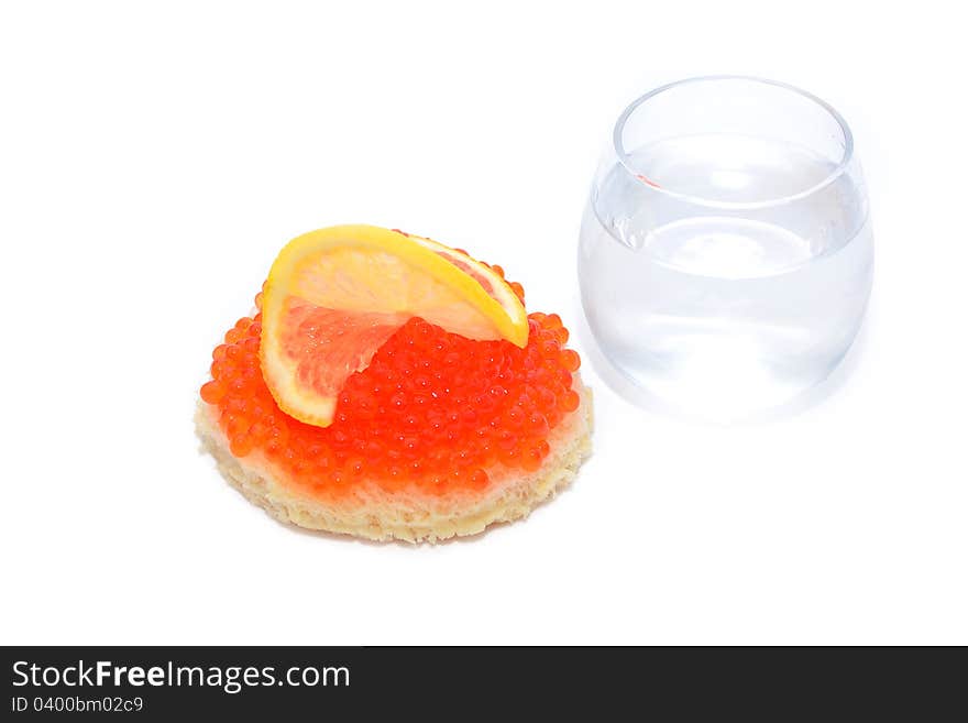 Bread with red caviar and glass of vodka isolated on white. Bread with red caviar and glass of vodka isolated on white