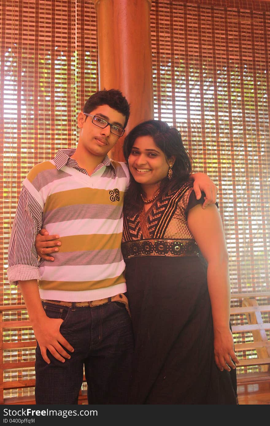 Indian Brother and Sister Happily Hugging in a nice studio indoor.