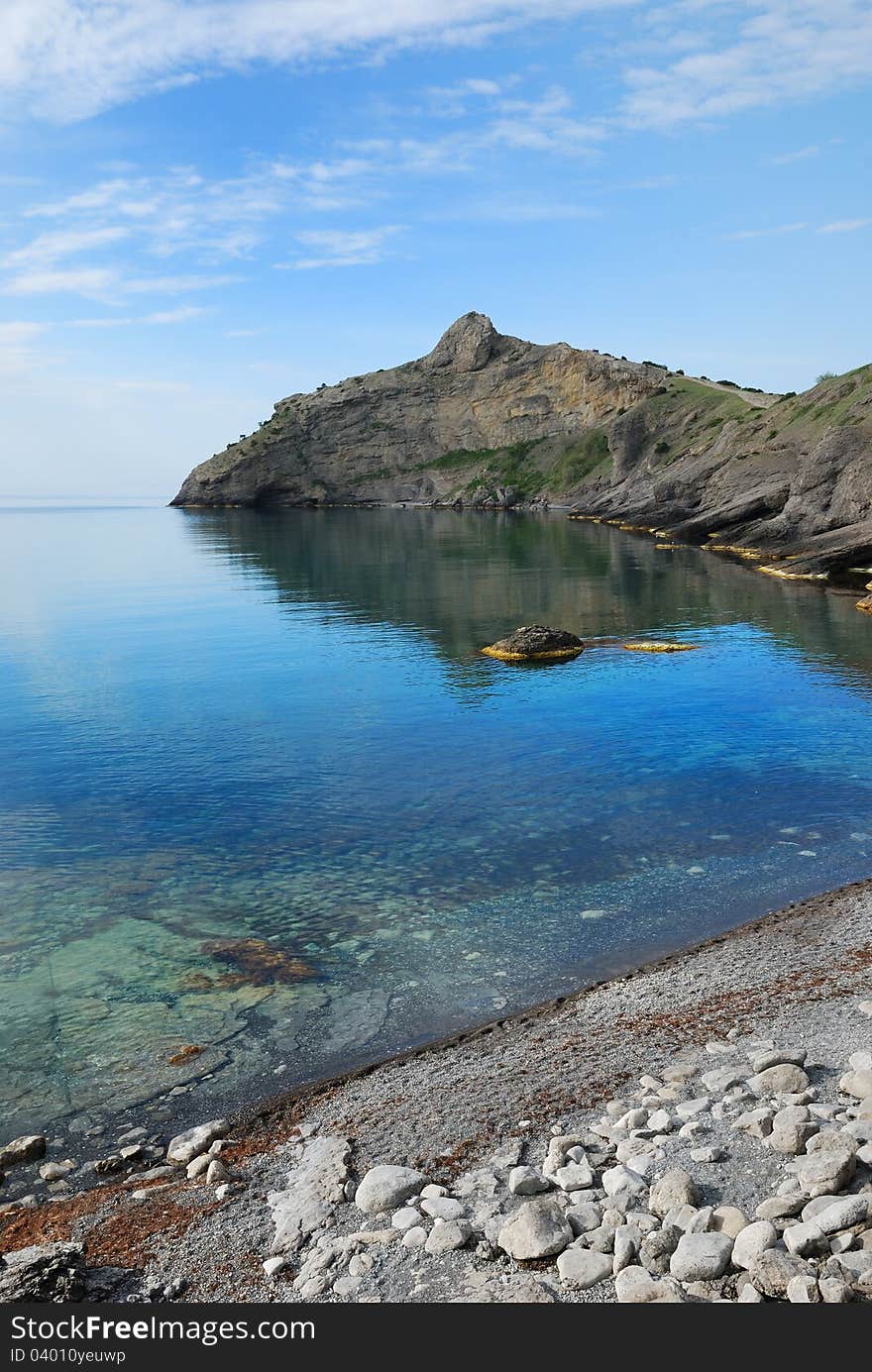 The pointed cape juts far into the Black Sea. This headland together with cape Hoba-Kaya have formed the Blue bay of Novij Svet. The pointed cape juts far into the Black Sea. This headland together with cape Hoba-Kaya have formed the Blue bay of Novij Svet.