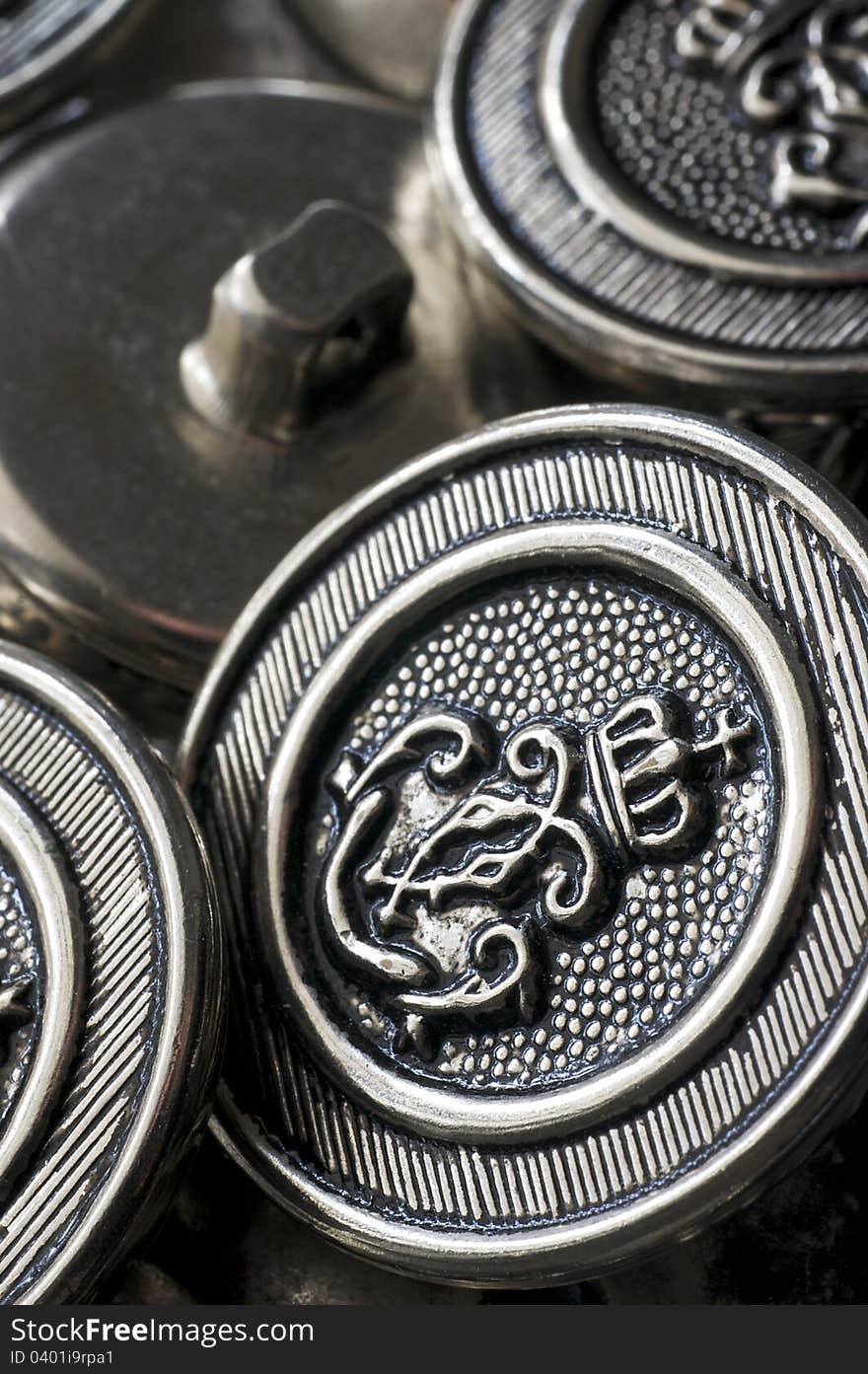 A collection of vintage naval buttons are a staple in a tailor's sewing kit. A collection of vintage naval buttons are a staple in a tailor's sewing kit.