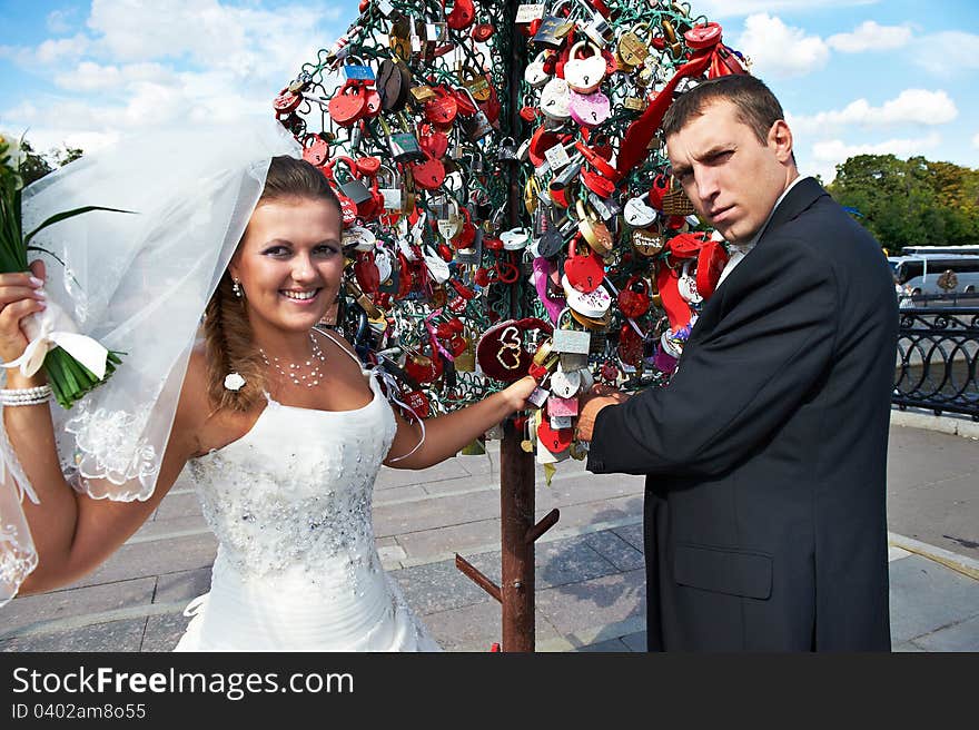 Happy Bride And Groom About Padlocks Tree