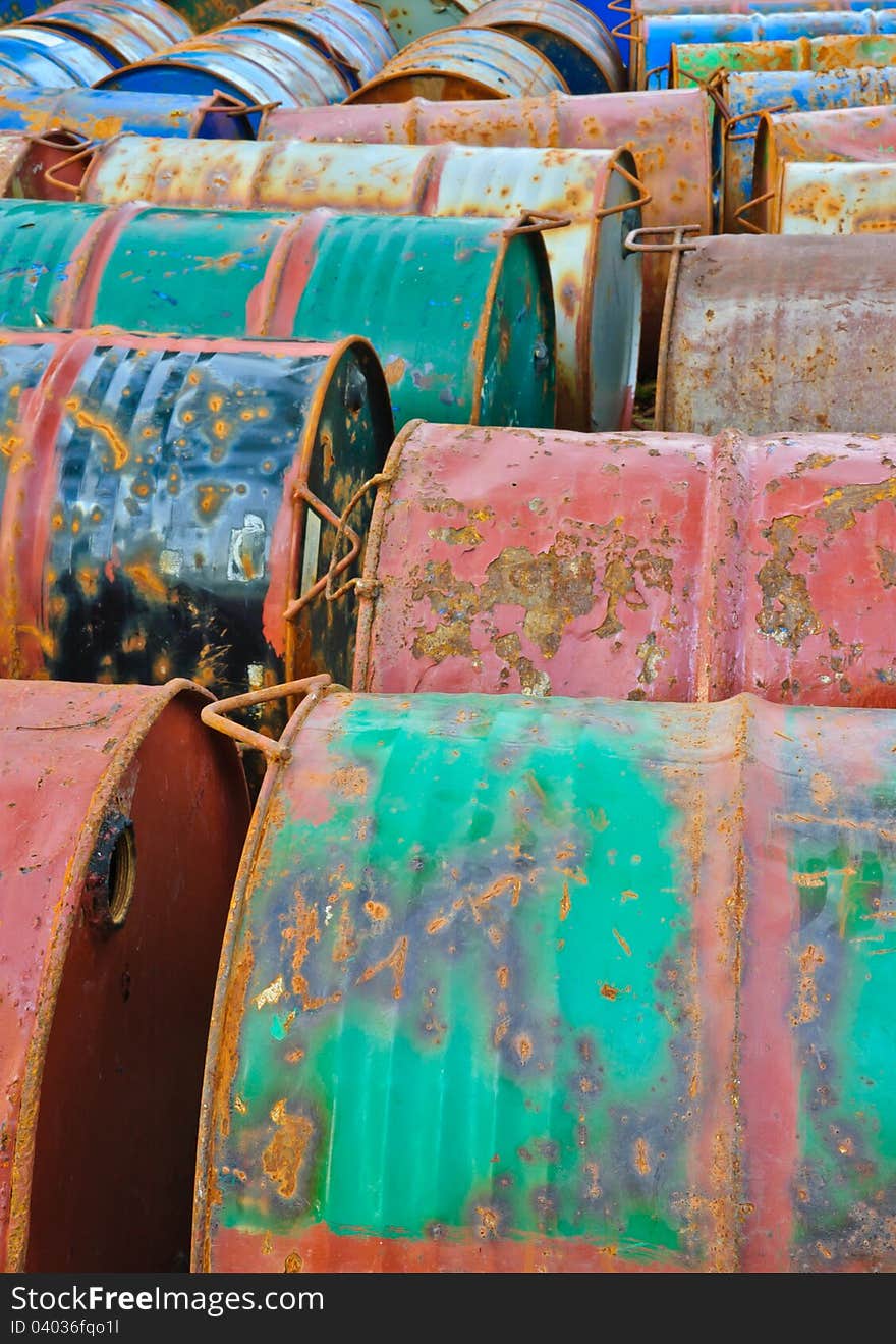 Row of rusty metal drums