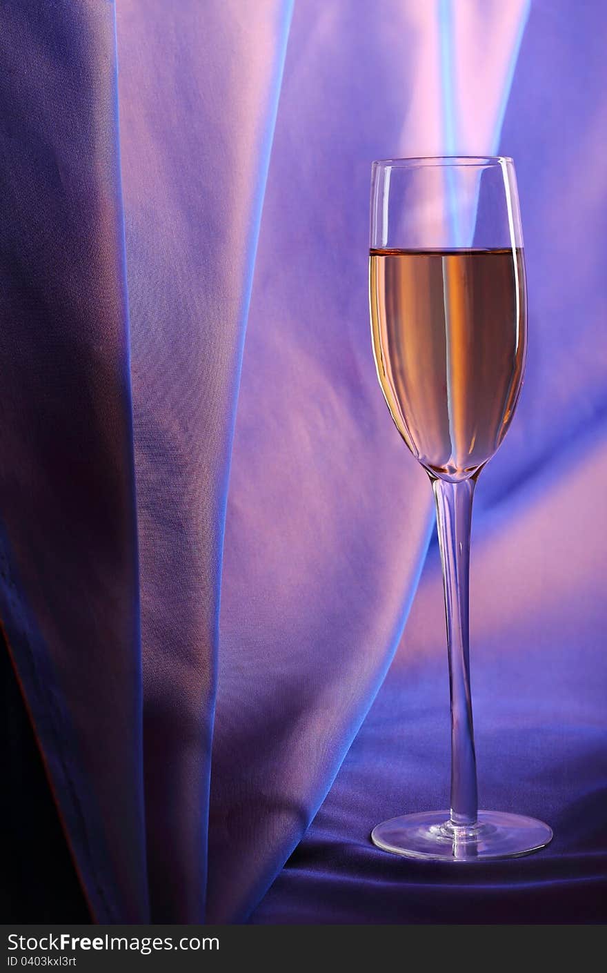 Celebratory glass of champagne on a dark blue background