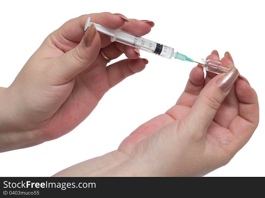 Woman hands filling a syringe against white background