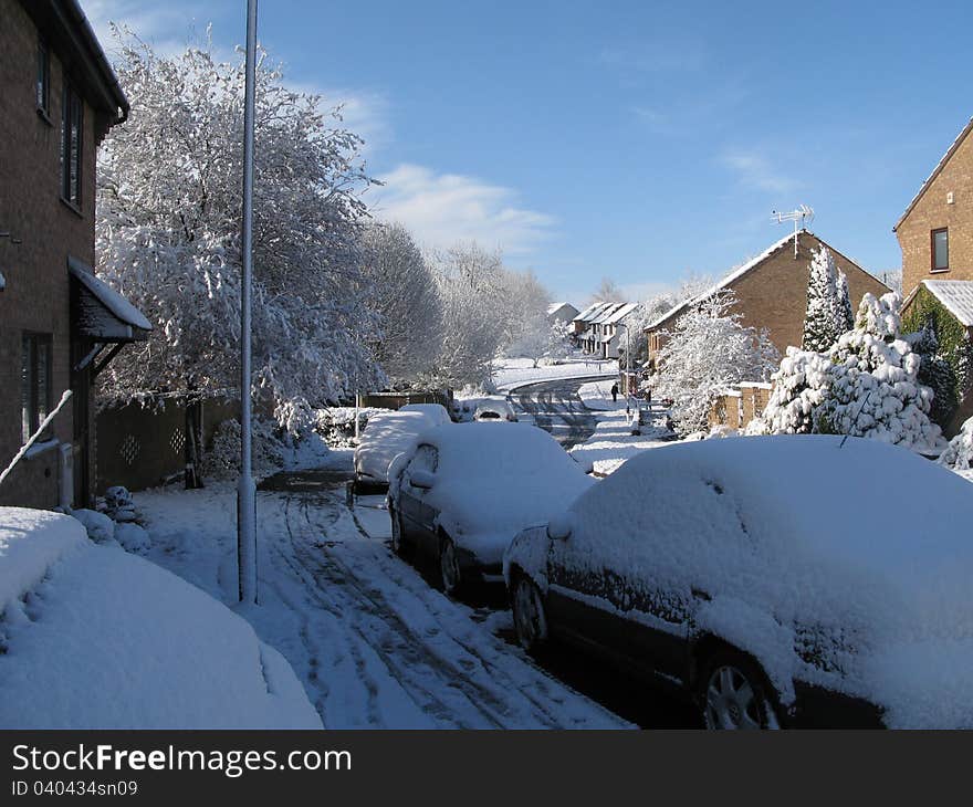 Snow covered housing estate under blue sky. Snow covered housing estate under blue sky