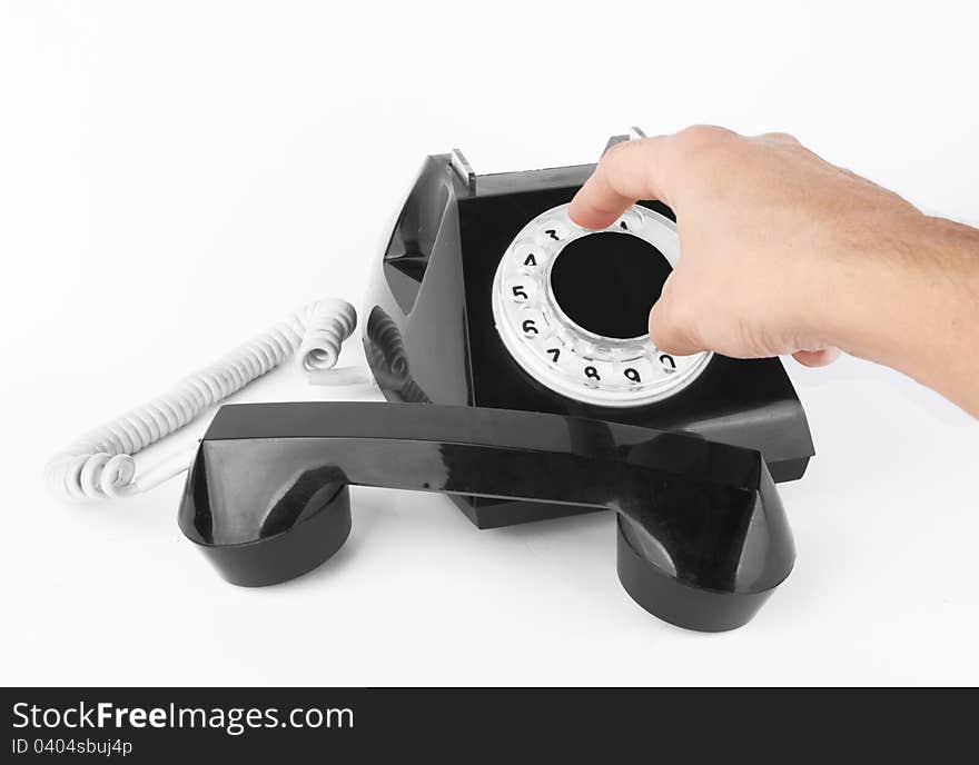 Black old phone with hand on white background