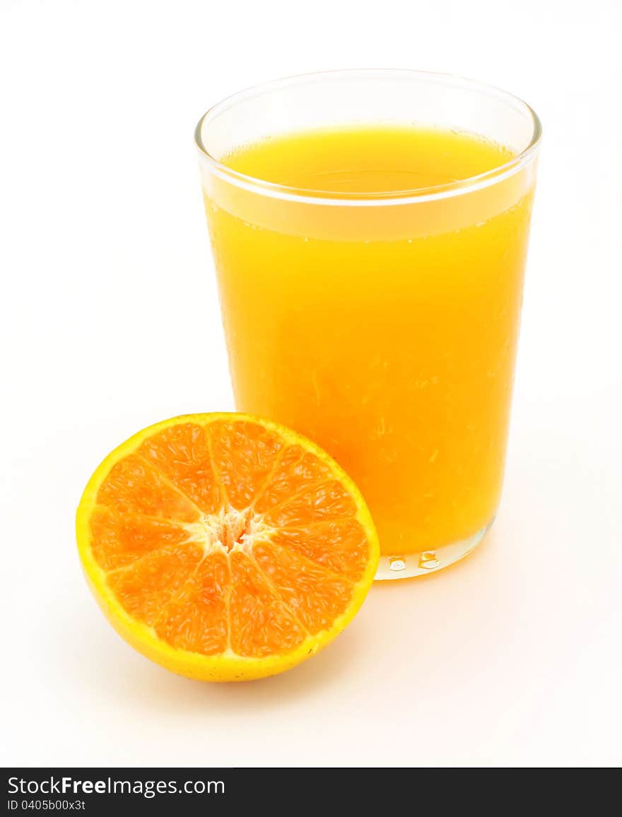 Tangerine and juice glass on white background